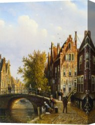 View of a Riverside Dutch Town Canvas Paintings - A Dutch town with figures on a canal by Johannes Franciscus Spohler